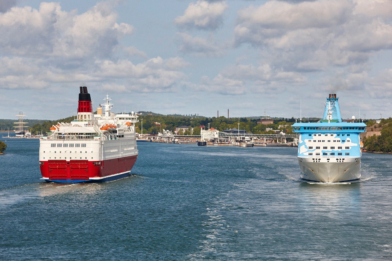 Two Baltic Sea ferries pass each other off Mariehamn, a red-and-white ship on the left.